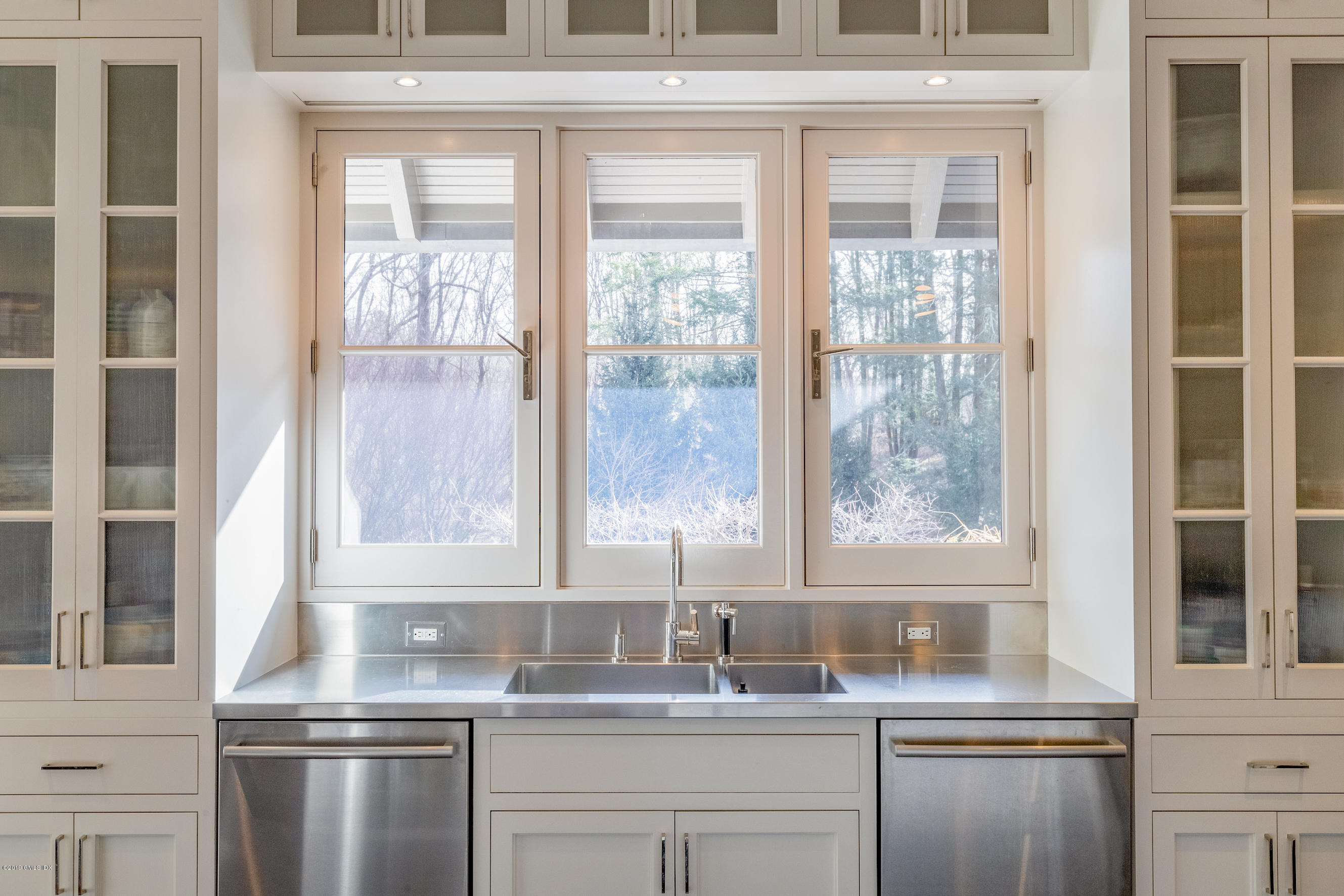 373 Riverbank Road Stamford, CT 06903 - Photo 8 of 35 a kitchen with stainless steel appliances granite countertop a sink and a window