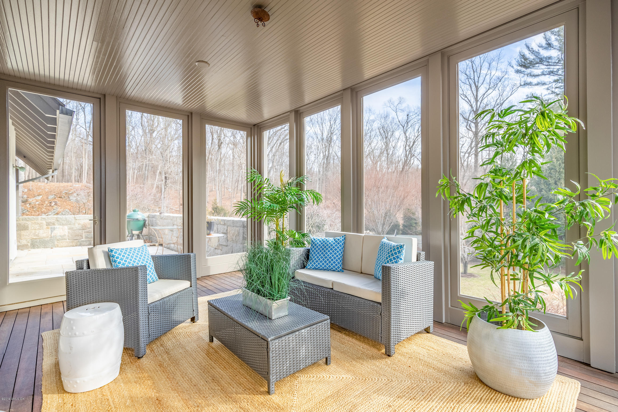 373 Riverbank Road Stamford, CT 06903 - Photo 10 of 35 a living room with furniture and a potted plant