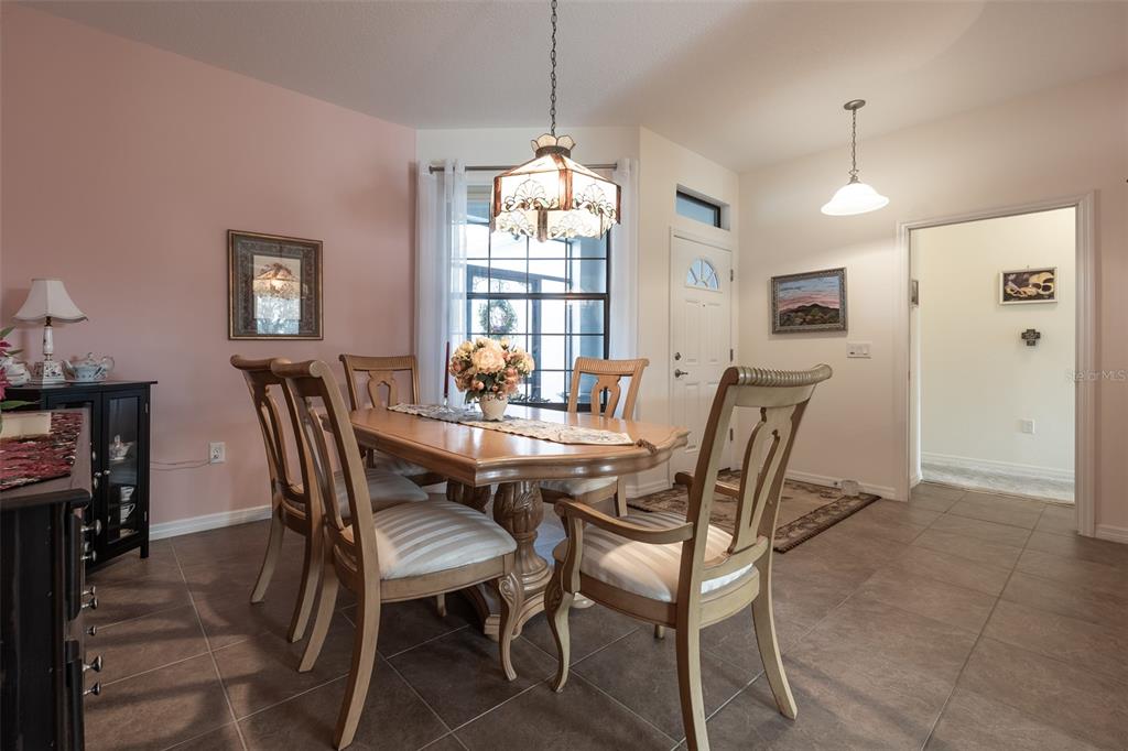 15969 Southwest 14th Avenue Road Ocala, FL 34473 - Photo 7 of 46 a view of a dining room with furniture window and wooden floor
