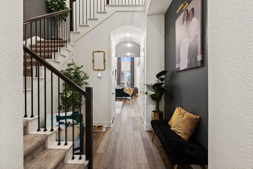 a view of entryway and hall with wooden floor