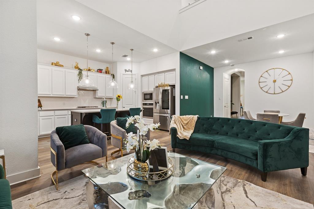 1124 Queensdown Way Forney, TX 75126 - Photo 15 of 34 a living room with furniture kitchen view and a table