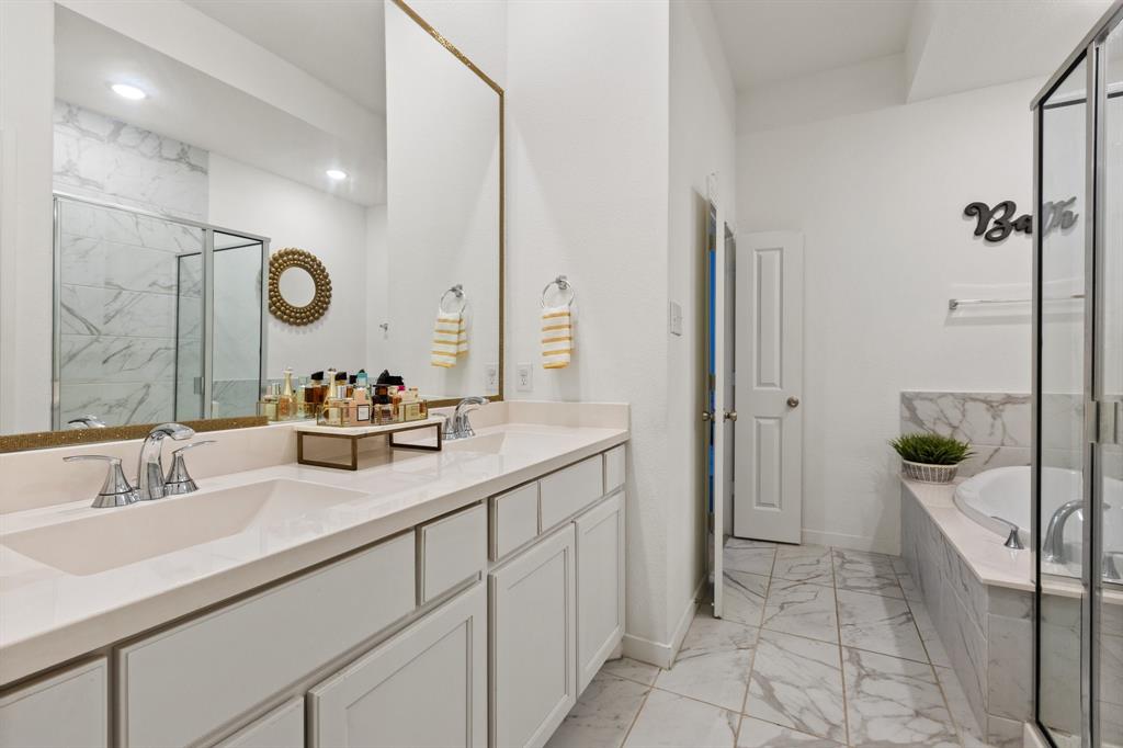 1124 Queensdown Way Forney, TX 75126 - Photo 20 of 34 a bathroom with a double vanity sink mirror and shower