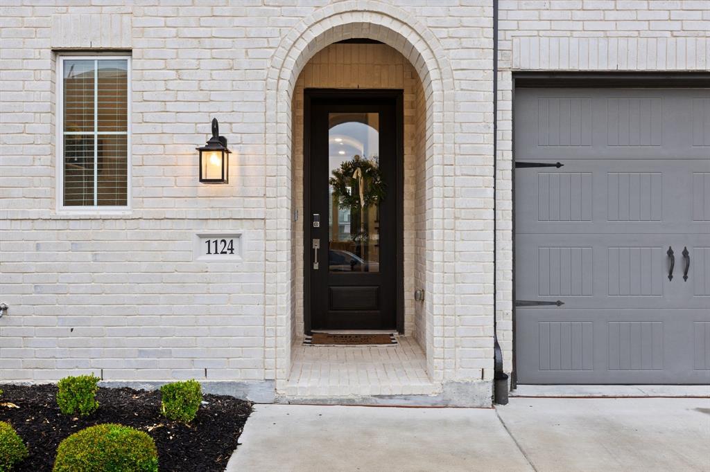 1124 Queensdown Way Forney, TX 75126 - Photo 2 of 34 a view of a brick house with potted plants