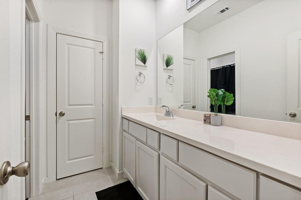 1124 Queensdown Way Forney, TX 75126 - Photo 24 of 34 a bathroom with a double vanity sink and mirror