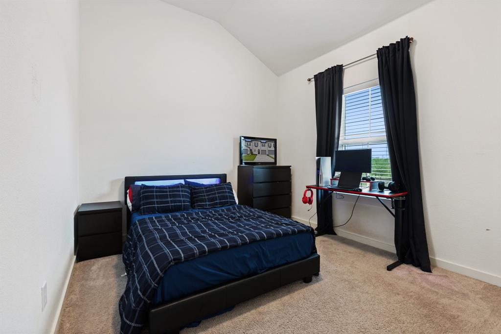 1124 Queensdown Way Forney, TX 75126 - Photo 25 of 34 a bedroom with a bed and a desk