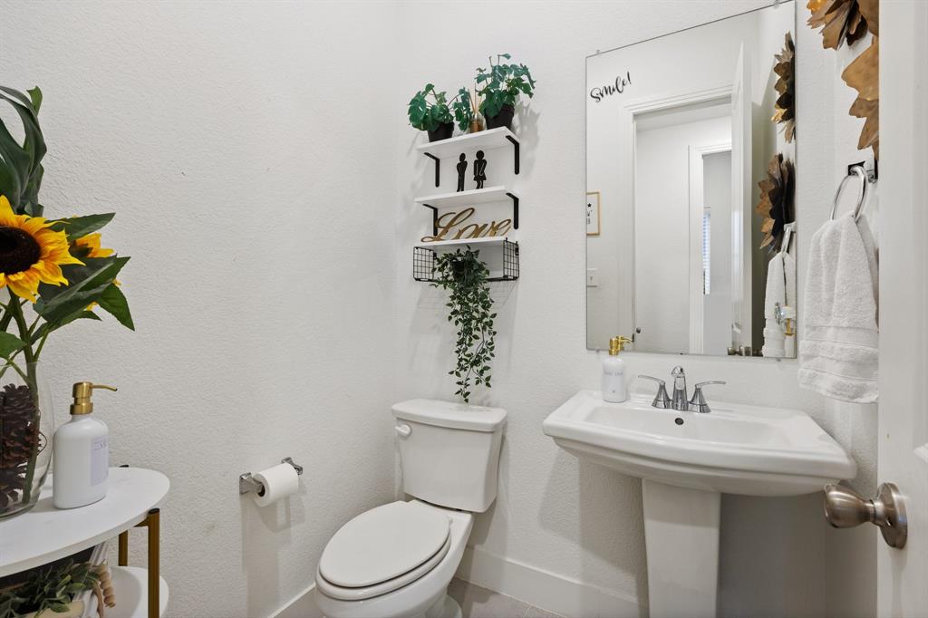 1124 Queensdown Way Forney, TX 75126 - Photo 26 of 34 a bathroom with a sink toilet and mirror