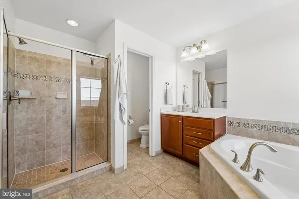 a spacious bathroom with a granite countertop sink mirror and shower