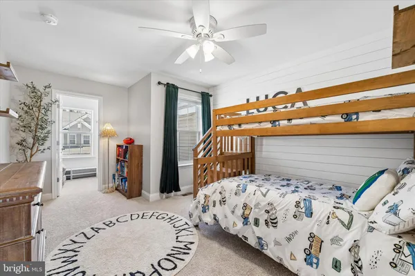 a bedroom with bed and a white cabinets