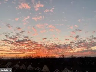 a view of a white house with a swimming pool