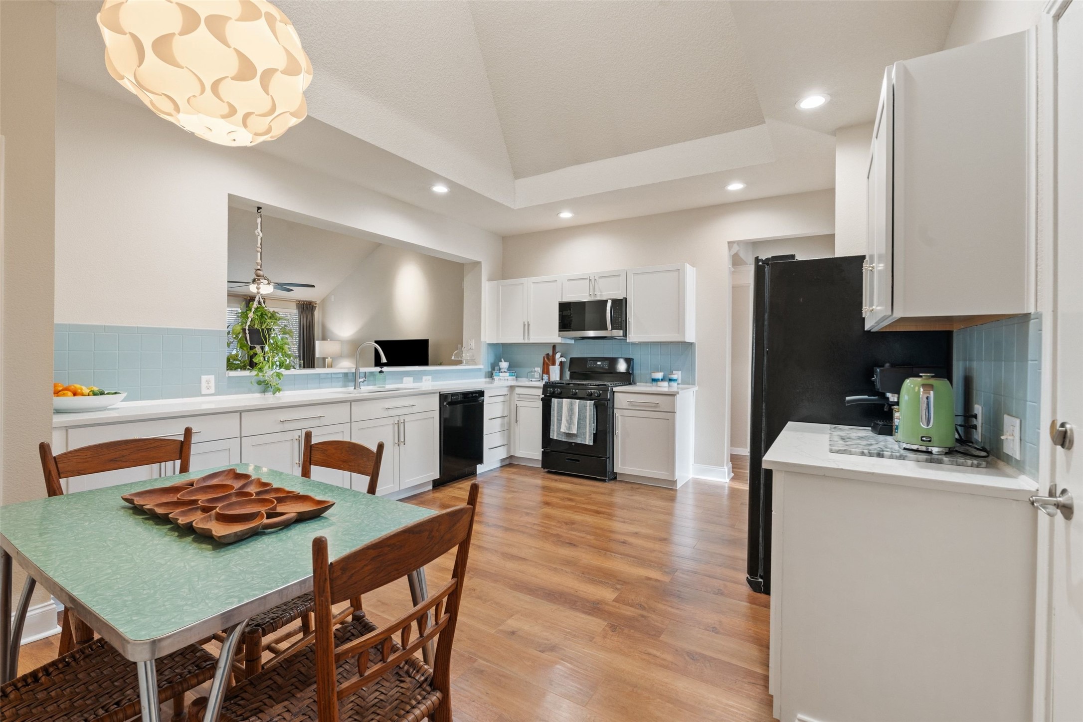 11016 Amaranth Lane Austin, TX 78754 - Photo 11 of 36 a kitchen with kitchen island a stove a table and chairs in it