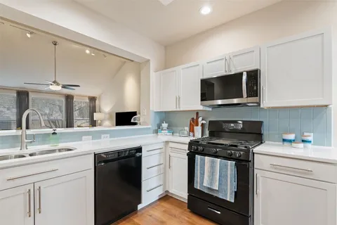 a kitchen with stainless steel appliances a stove a microwave and cabinets