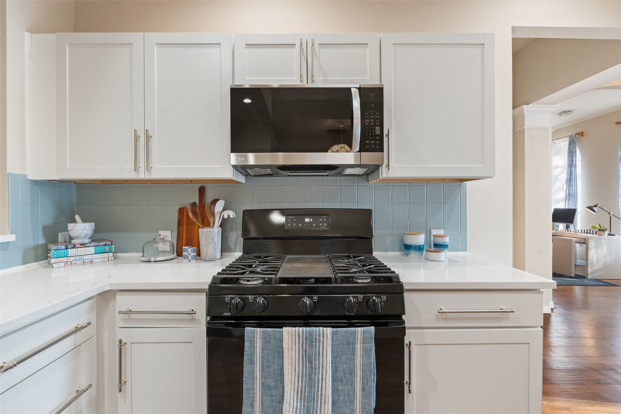 11016 Amaranth Lane Austin, TX 78754 - Photo 15 of 36 a kitchen with stainless steel appliances a stove a microwave and cabinets