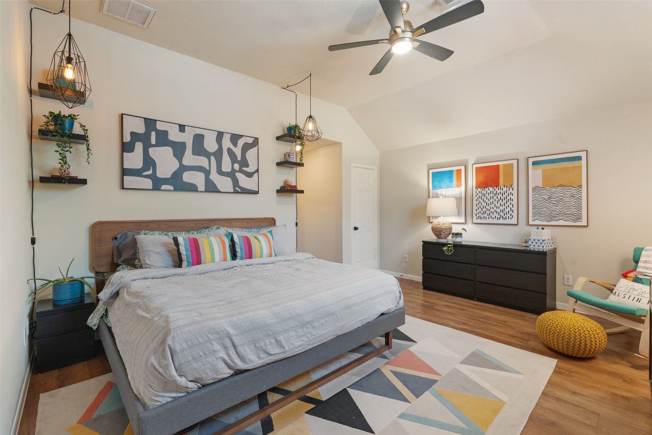 11016 Amaranth Lane Austin, TX 78754 - Photo 17 of 36 a bedroom with a bed and wooden floor