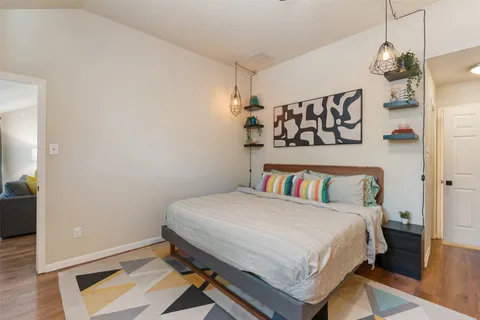 a bedroom with a bed and a chandelier