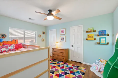 a living room with furniture and a baby crib