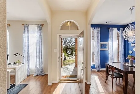 a view of a bedroom with furniture window and wooden floor