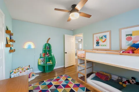 a bedroom with a bed and a chandelier