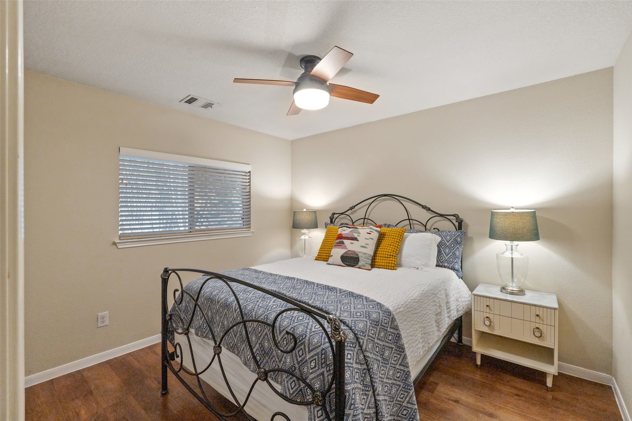11016 Amaranth Lane Austin, TX 78754 - Photo 23 of 36 a bedroom with a bed and a chandelier