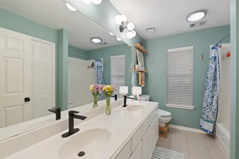 a view of walk in closet with clothes