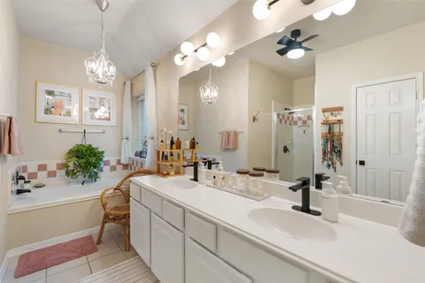 a bathroom with a tub sink and mirror