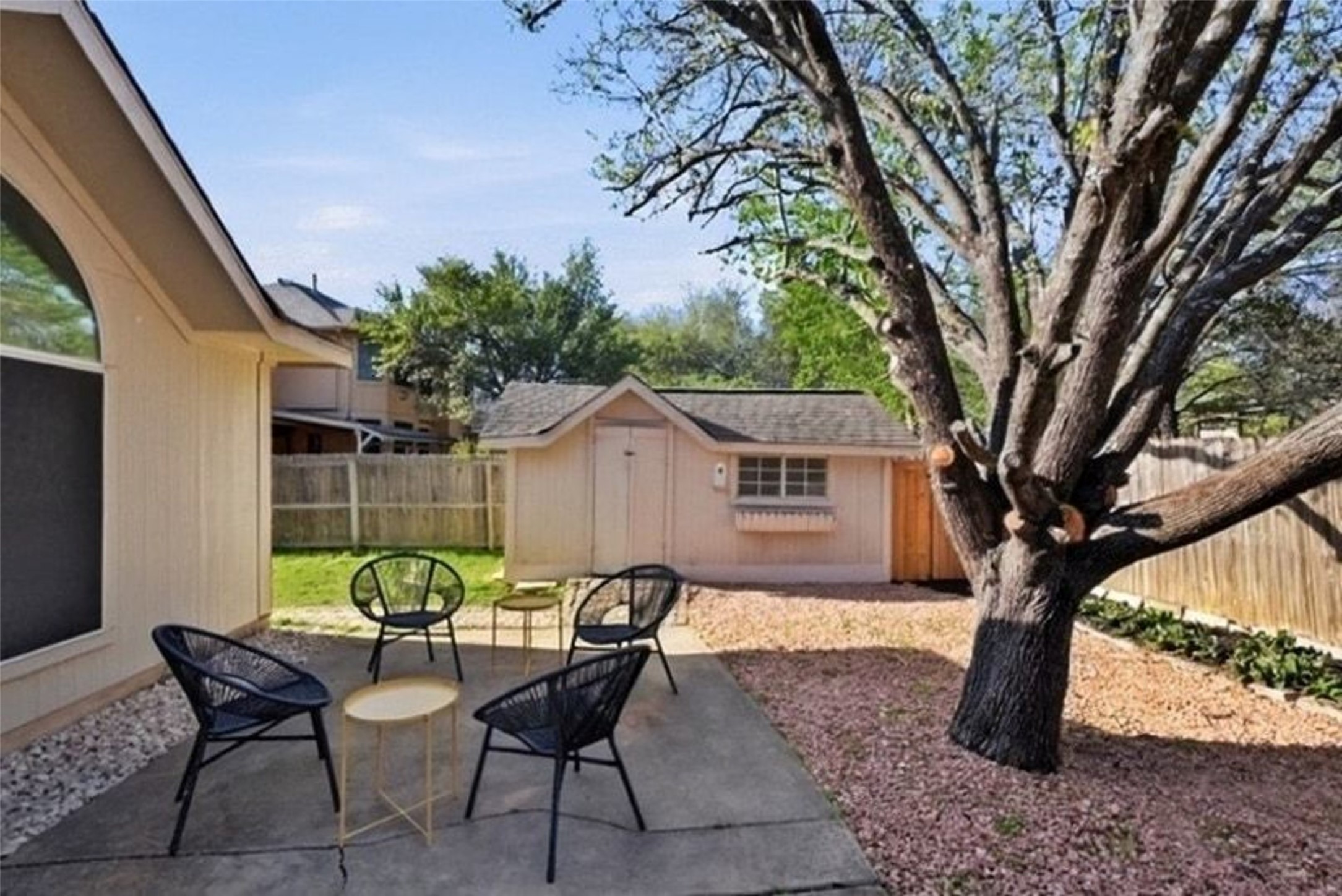 11016 Amaranth Lane Austin, TX 78754 - Photo 34 of 36 a view of a backyard with table and chairs and a large tree