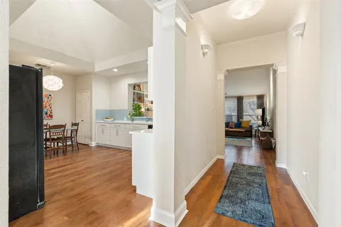 a kitchen with kitchen island a stove a table and chairs in it