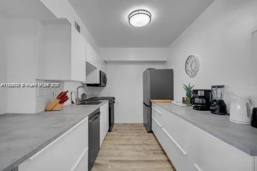 a kitchen with a sink and a stove top oven