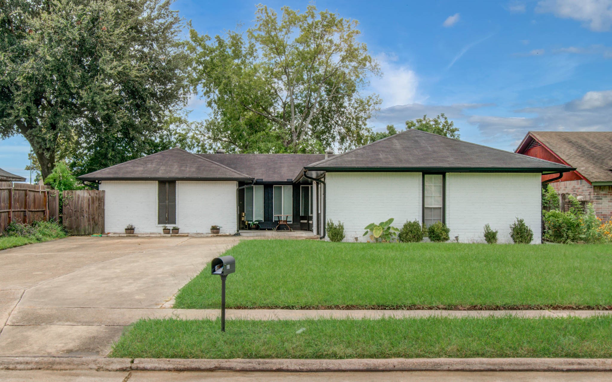 1327 Fallbrook Drive Houston, TX 77038 - Photo 1 of 34 a front view of a house with a garden