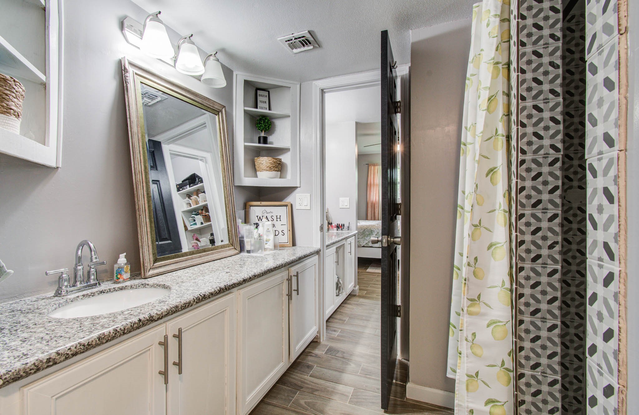 1327 Fallbrook Drive Houston, TX 77038 - Photo 20 of 34 a bathroom with a granite countertop sink and a mirror