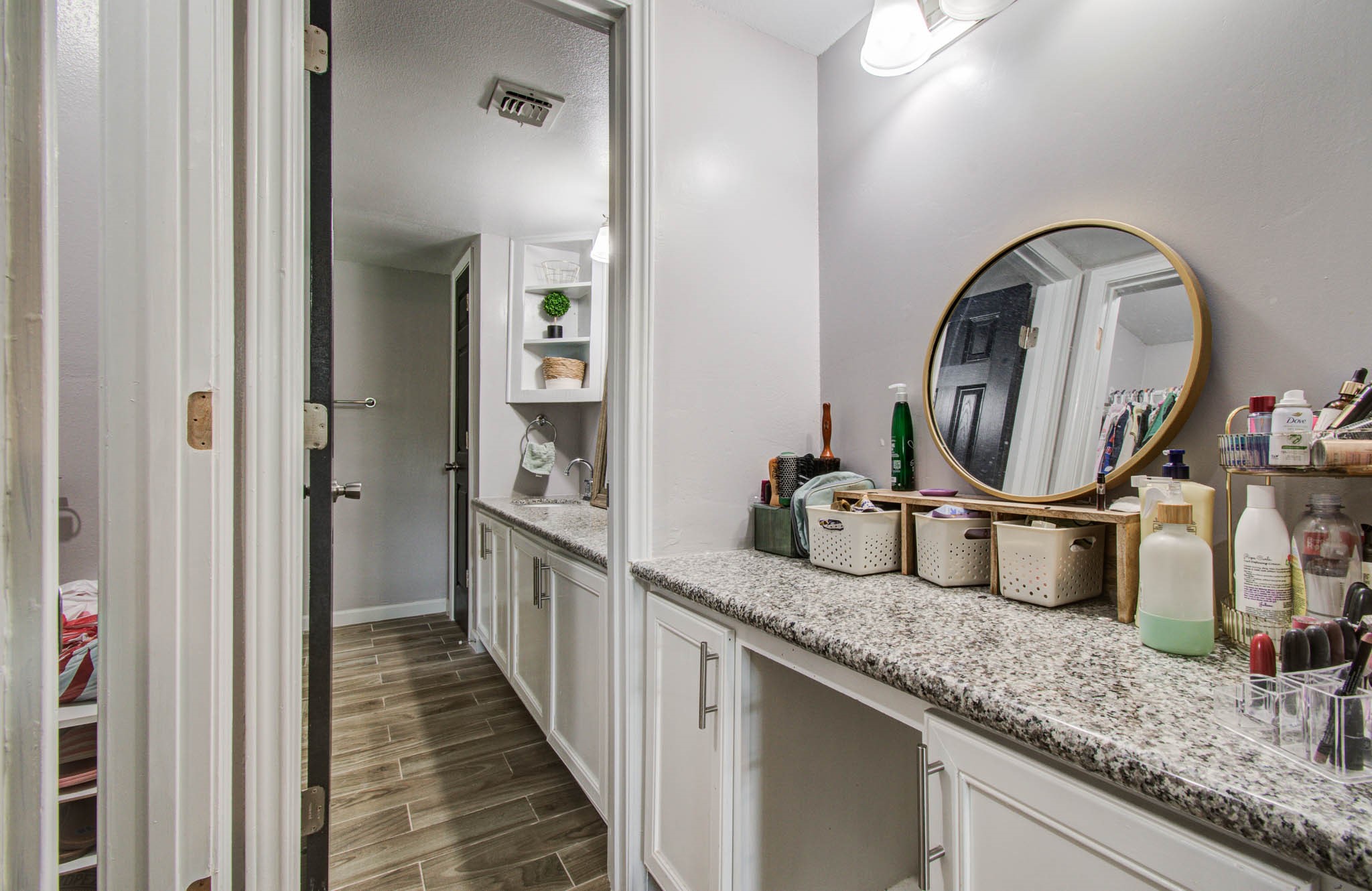 1327 Fallbrook Drive Houston, TX 77038 - Photo 21 of 34 a bathroom with a granite countertop sink a mirror and a shower