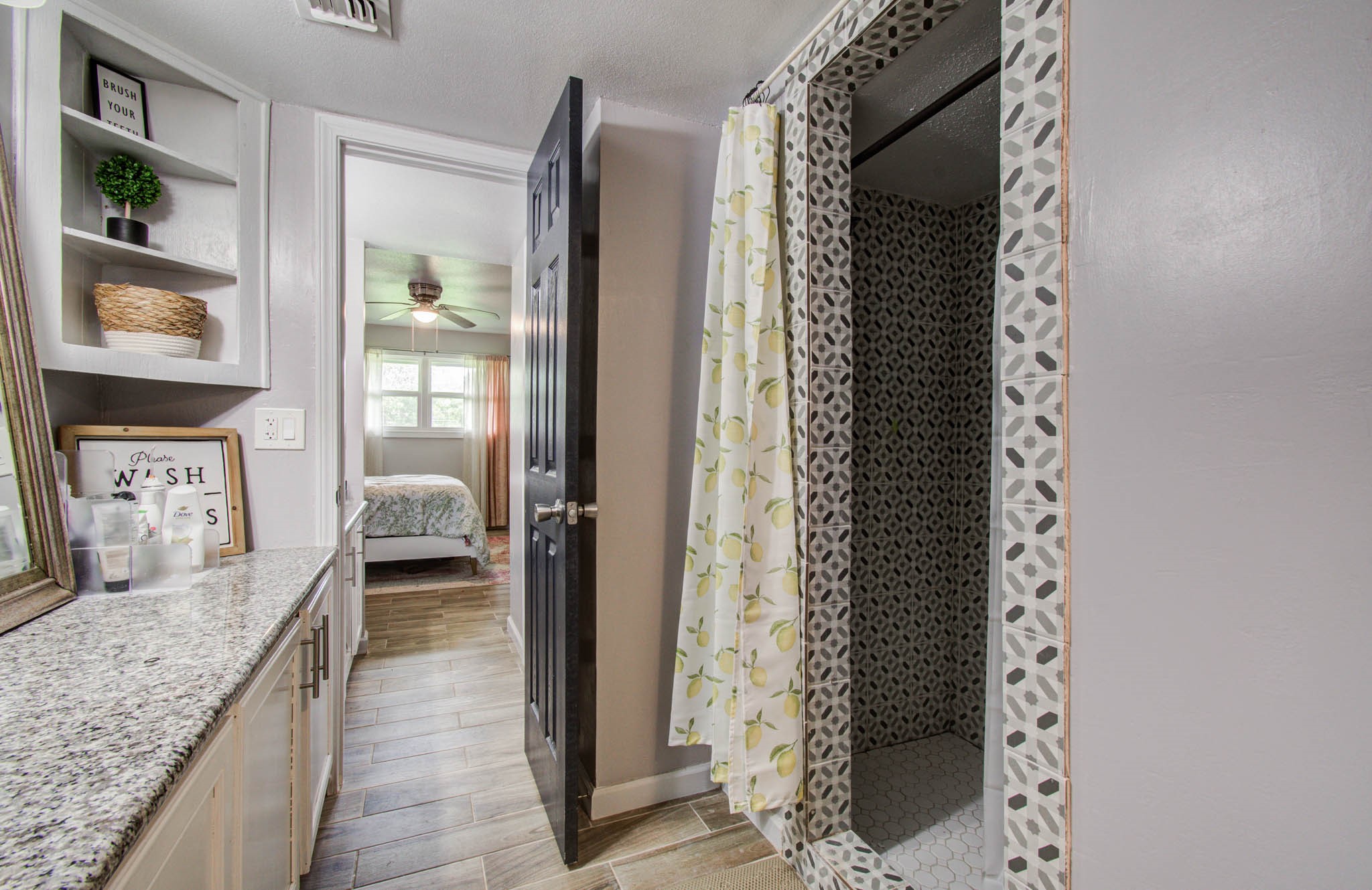 1327 Fallbrook Drive Houston, TX 77038 - Photo 22 of 34 a en suite bathroom with a granite countertop sink and a mirror