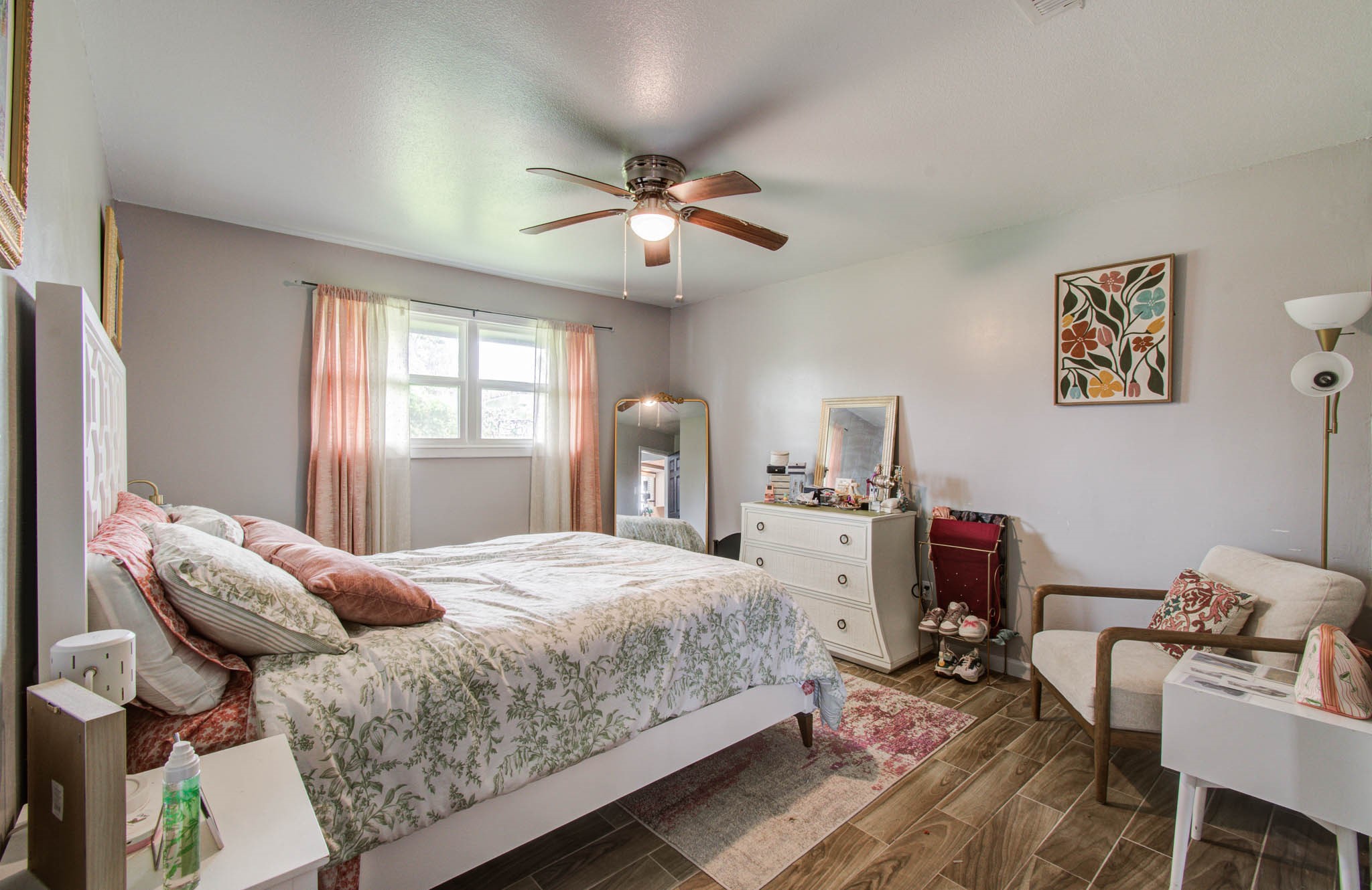 1327 Fallbrook Drive Houston, TX 77038 - Photo 23 of 34 a bedroom with a bed and a chandelier