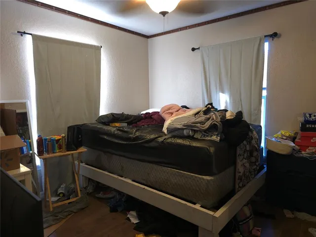 a bed sitting in a bedroom next to a window