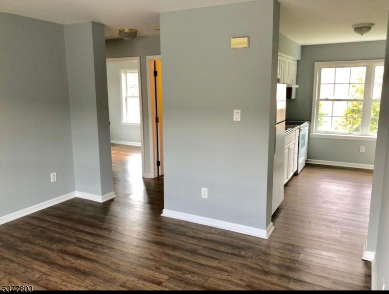 12 Cook Avenue Madison, NJ 07940 - Photo 3 of 7 an empty room with wooden floor and windows