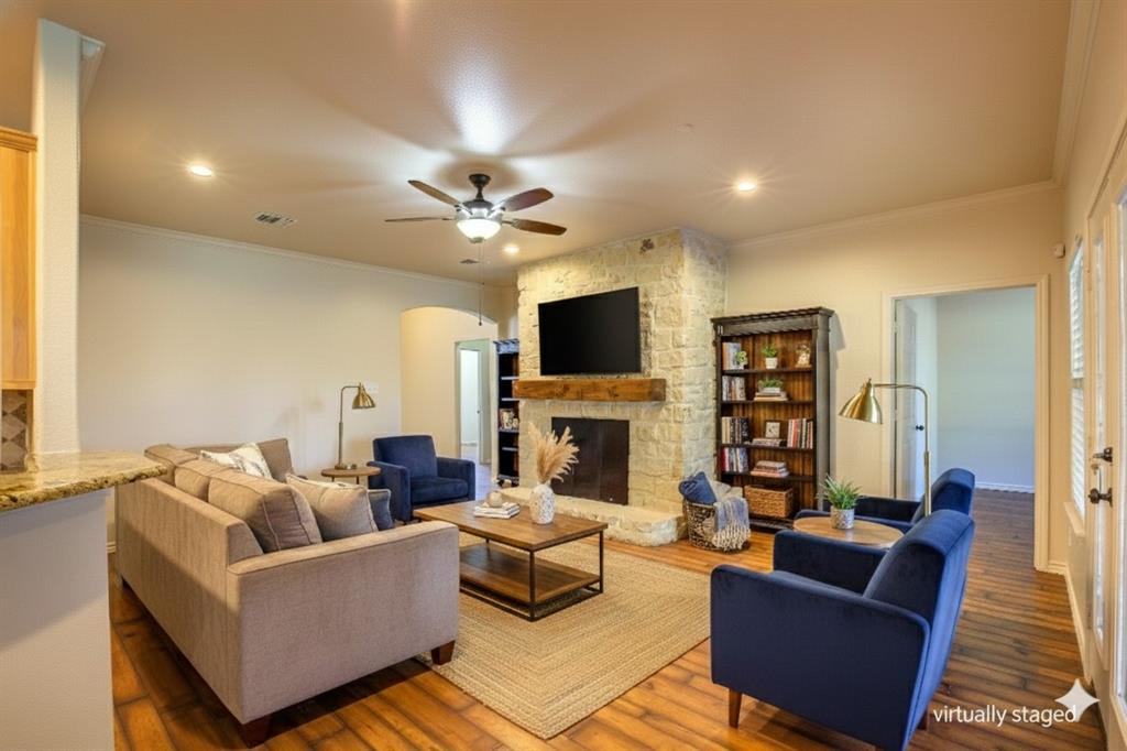 2617 Kirby Road Rowlett, TX 75088 - Photo 4 of 39 Virtually staged living room featuring arched walkways, ornamental molding, a fireplace, recessed lighting, and a ceiling fan