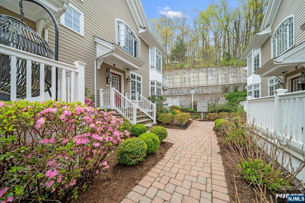 a view of a house with a lot of flower plants