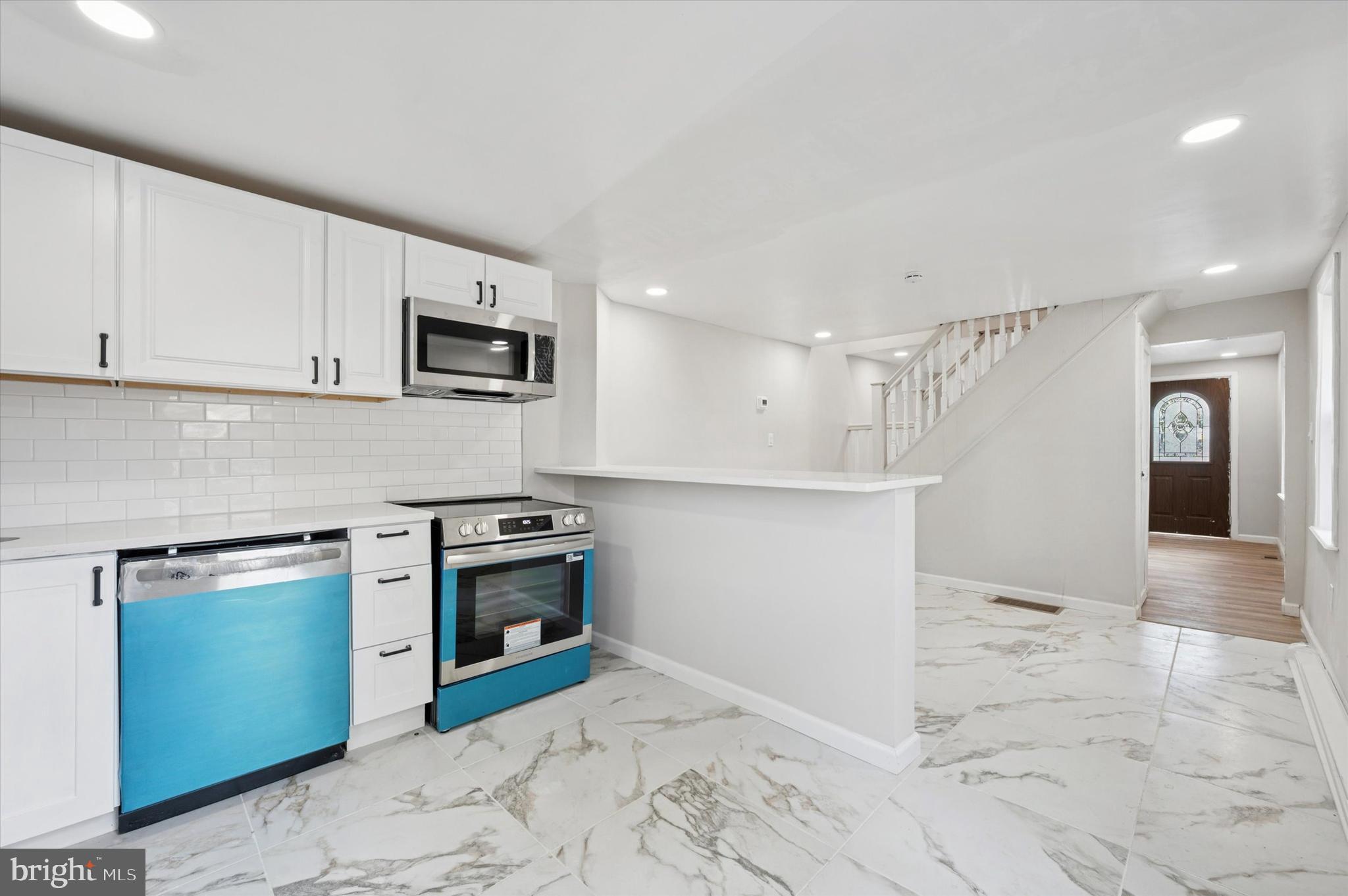 1339 Green Street Marcus Hook, PA 19061 - Photo 11 of 17 a kitchen with granite countertop a stove top oven and cabinets