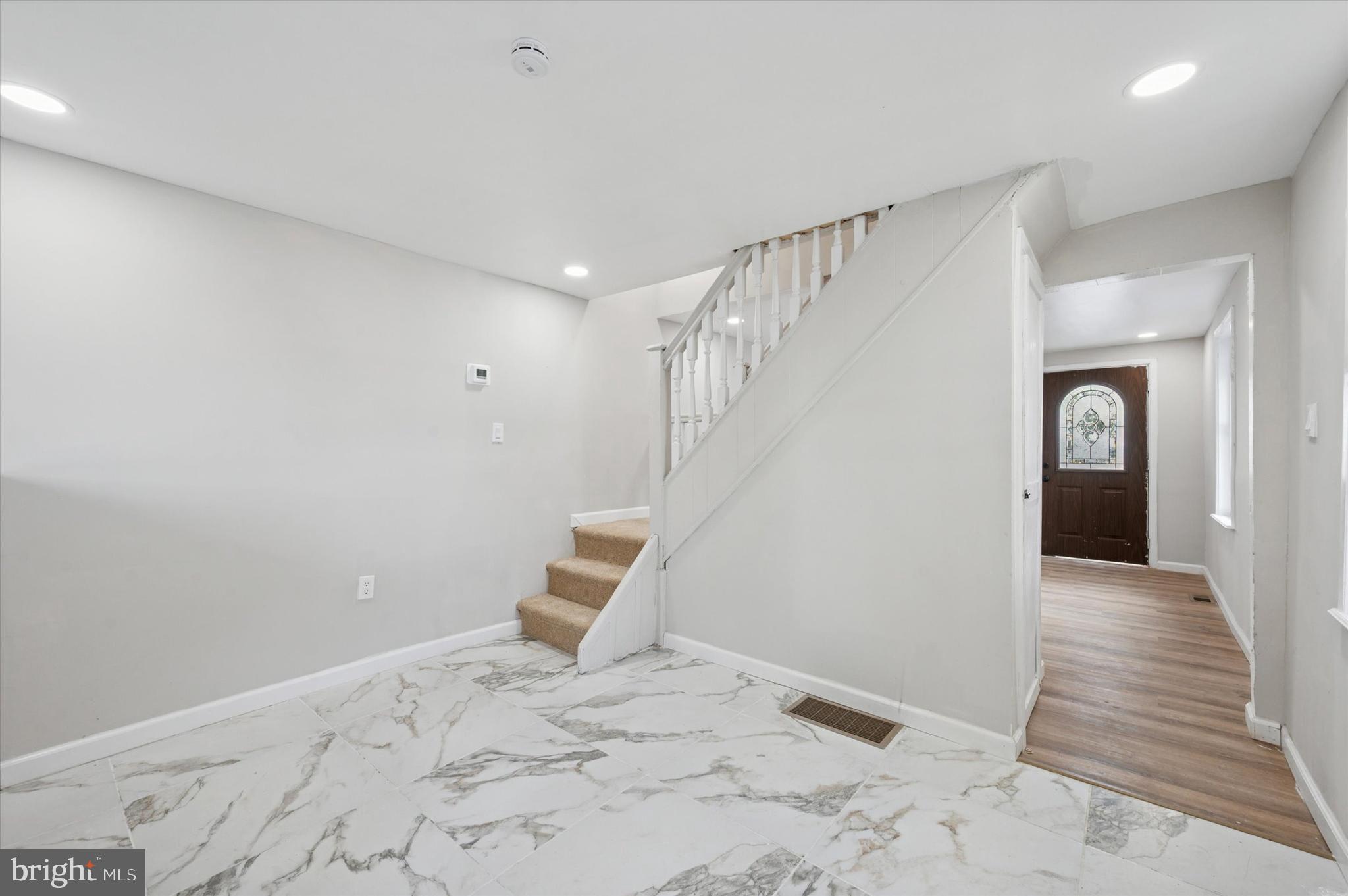 1339 Green Street Marcus Hook, PA 19061 - Photo 12 of 17 a view of a hallway to a bedroom with wooden floor and stairs