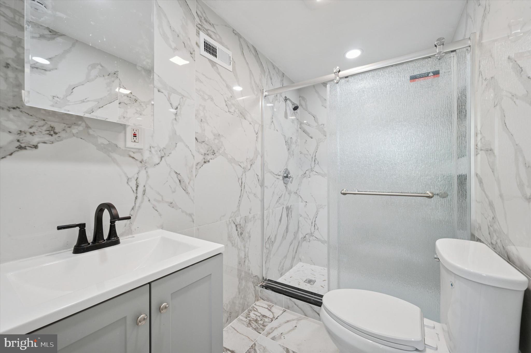 1339 Green Street Marcus Hook, PA 19061 - Photo 15 of 17 a bathroom with a sink a toilet and shower