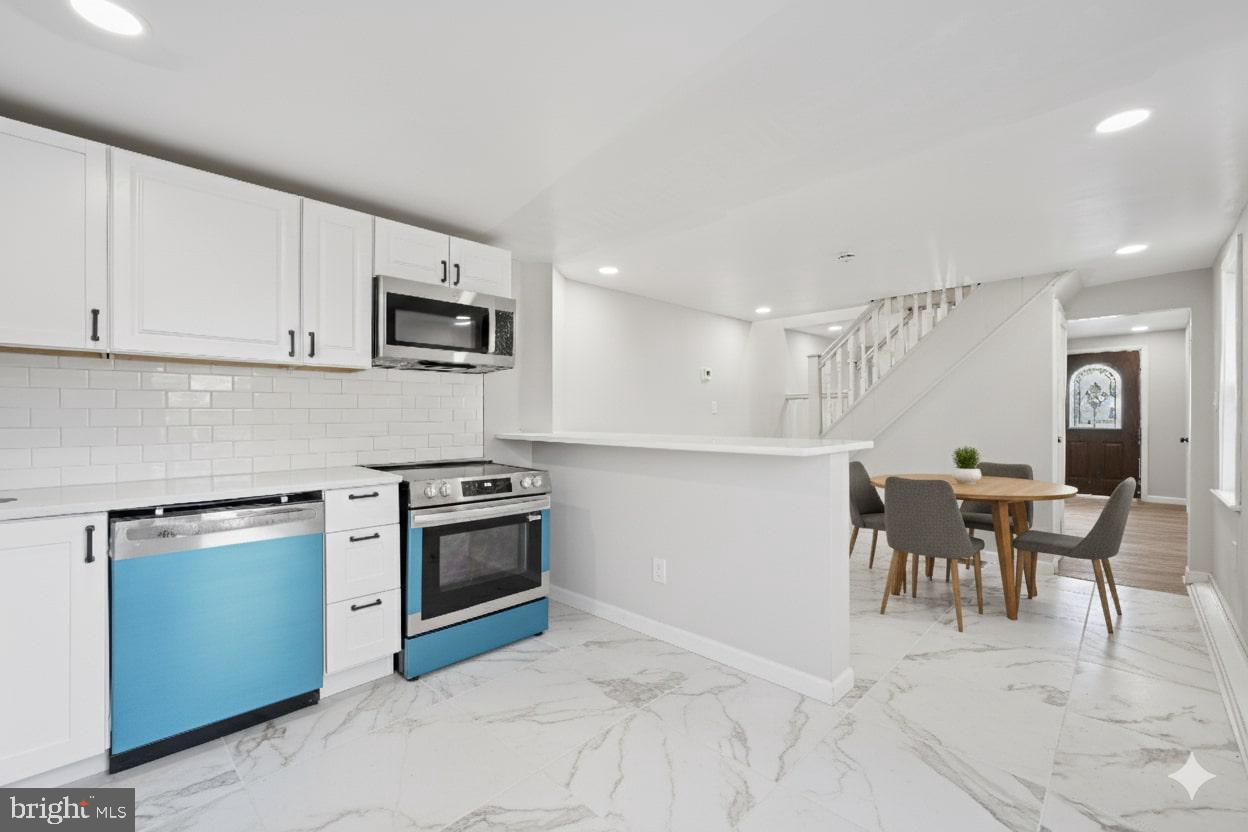 1339 Green Street Marcus Hook, PA 19061 - Photo 3 of 17 a kitchen with stainless steel appliances granite countertop a stove and a sink