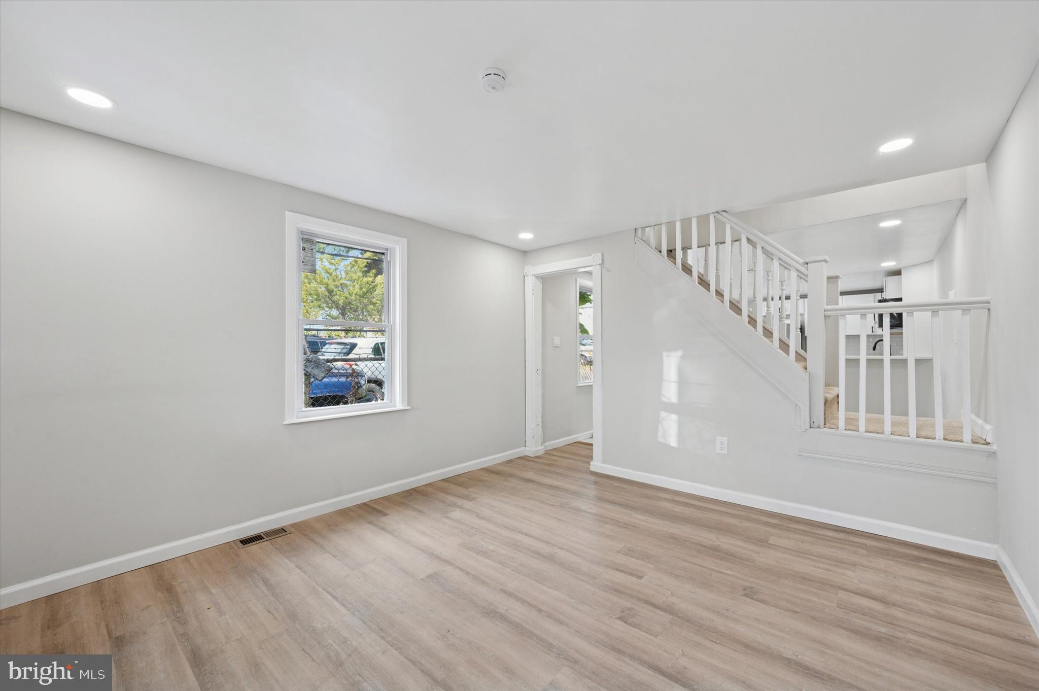 1339 Green Street Marcus Hook, PA 19061 - Photo 6 of 17 a view of an empty room with wooden floor and a window