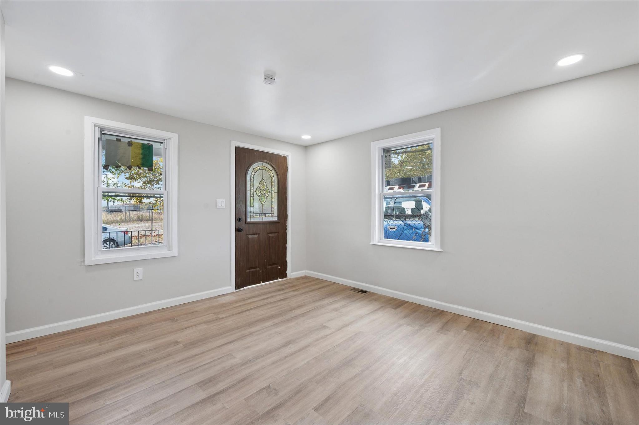 1339 Green Street Marcus Hook, PA 19061 - Photo 7 of 17 a view of an empty room with wooden floor and a window