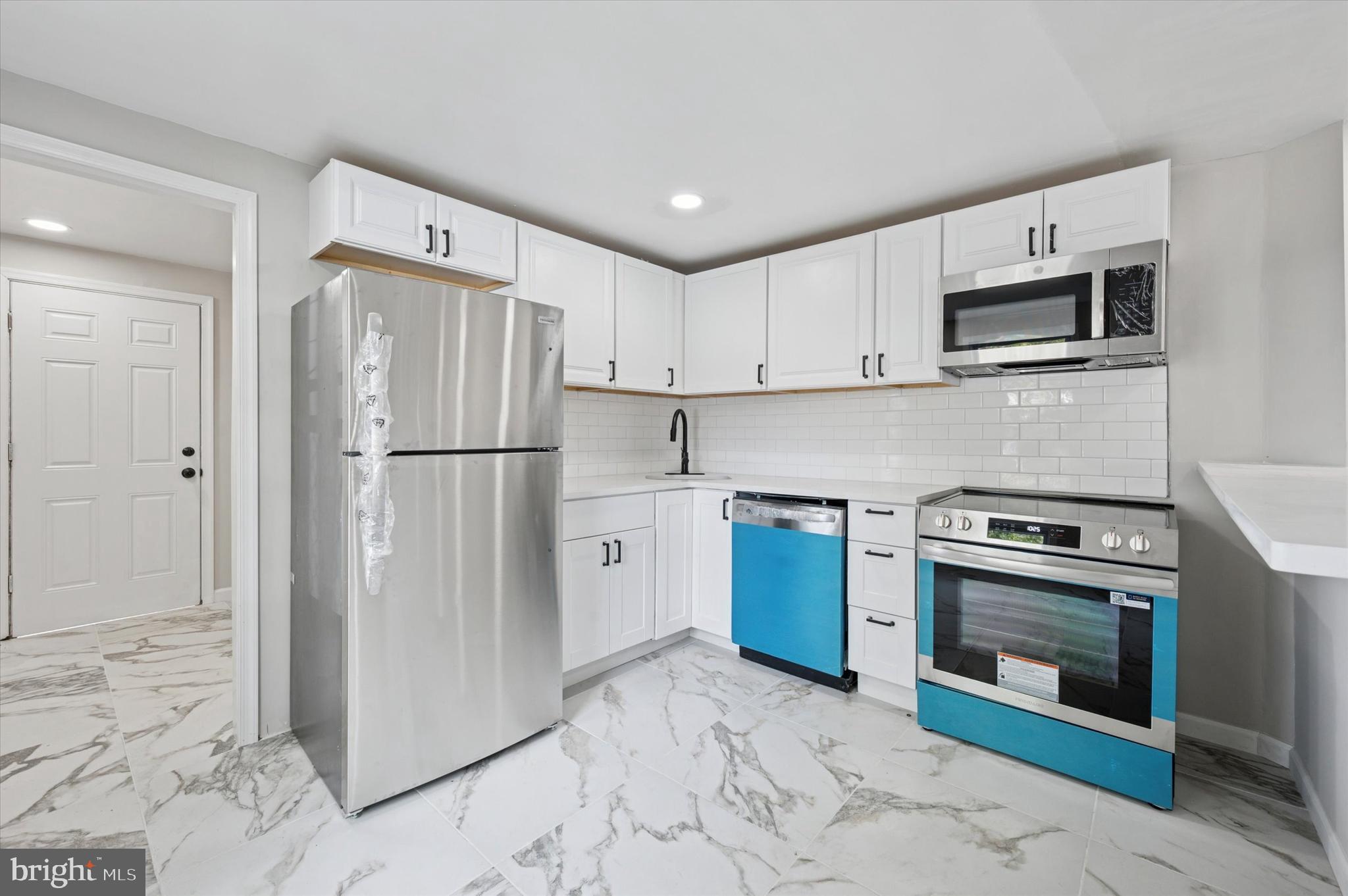 1339 Green Street Marcus Hook, PA 19061 - Photo 10 of 17 a kitchen with stainless steel appliances granite countertop a refrigerator stove and sink