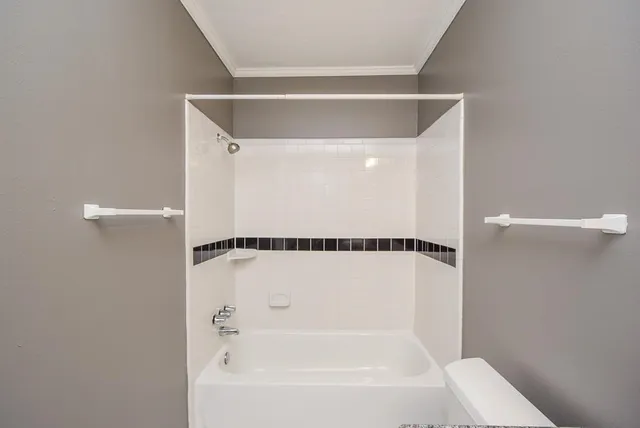 a bathroom with a shower and a bath tub