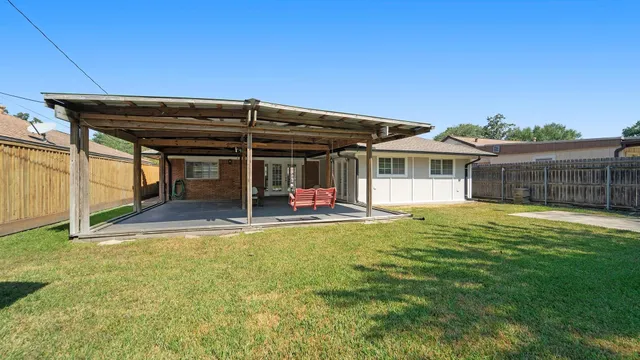 a view of a house with pool and a yard