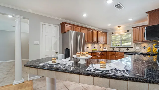 a kitchen with granite countertop a sink and a stove