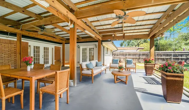 a outdoor space with patio lots of furniture and large windows