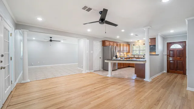 a view of kitchen with refrigerator microwave and stove