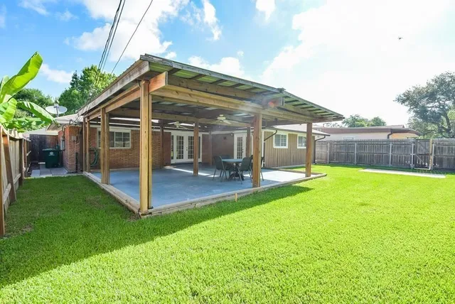a view of a house with a yard patio and a slide