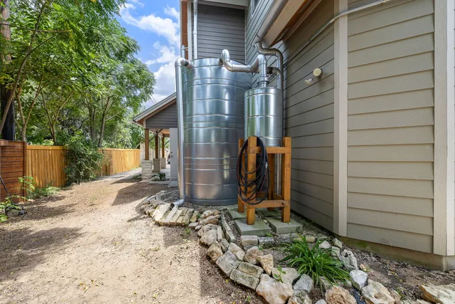 a front view of a house with a yard and potted plants